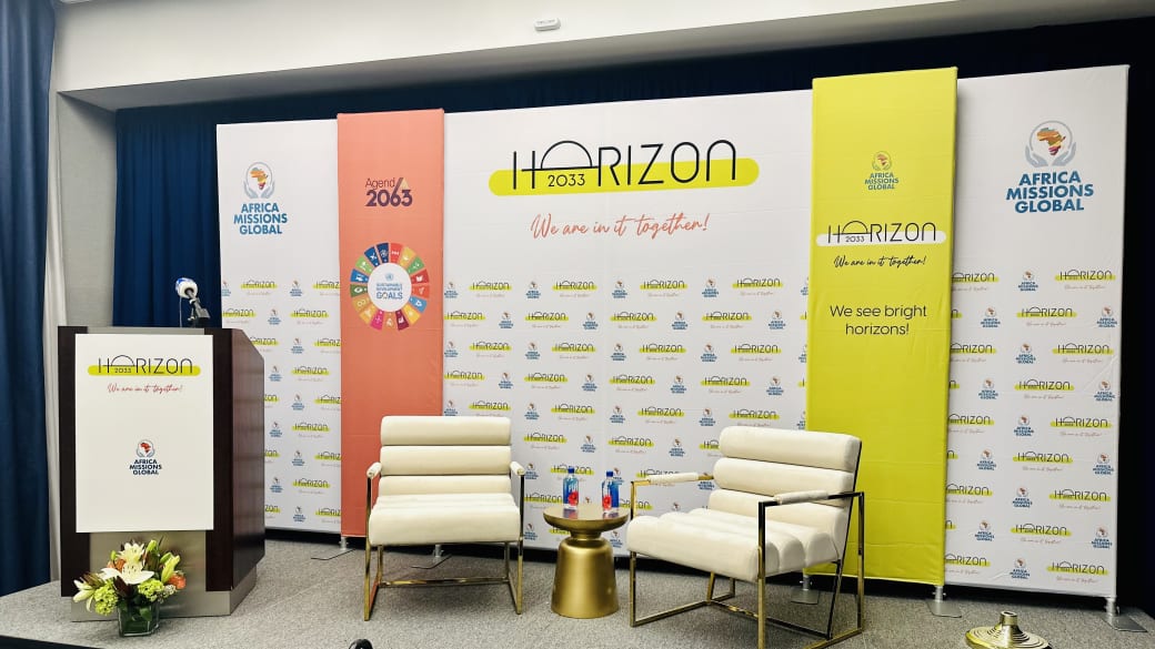 Step and repeat backdrop wall with fabric banners on the Horizon 2033 stage