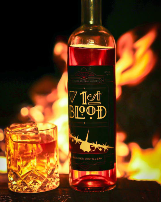 1st Blood and a poured glass, lit by an open fire.