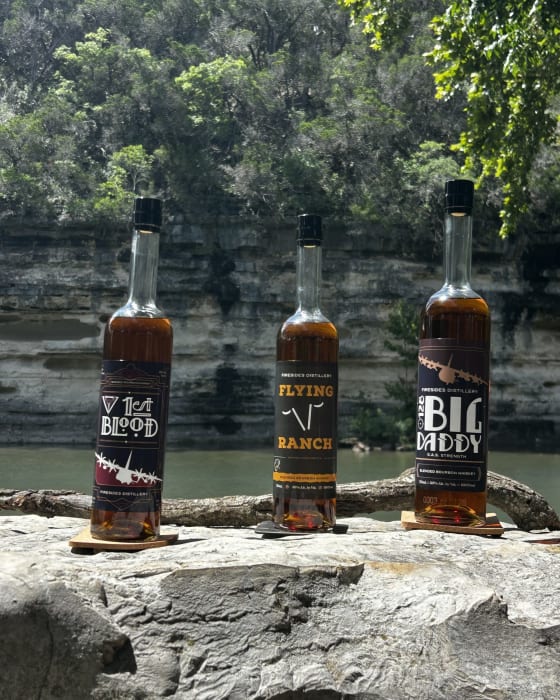 The three Firesides bottles up close on a river ledge.