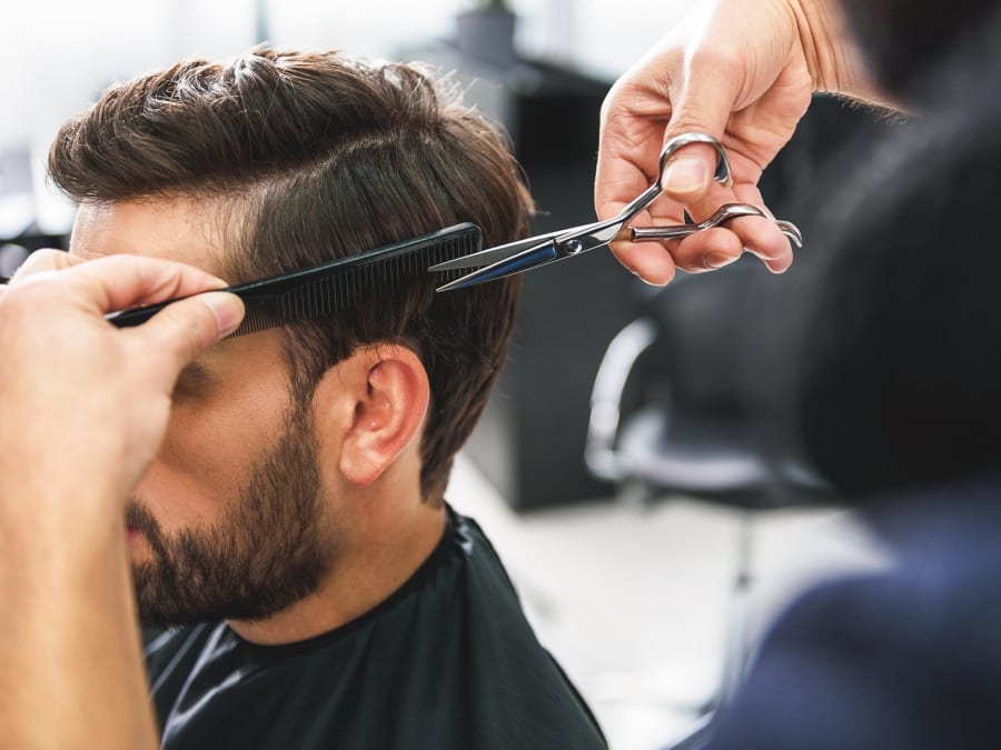Barber giving a precision haircut at Federico's