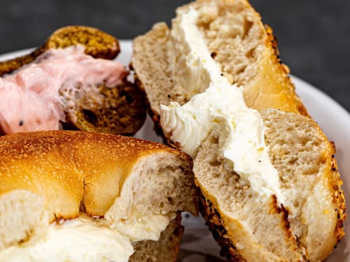 Bagel split with a thick cream cheese schmear