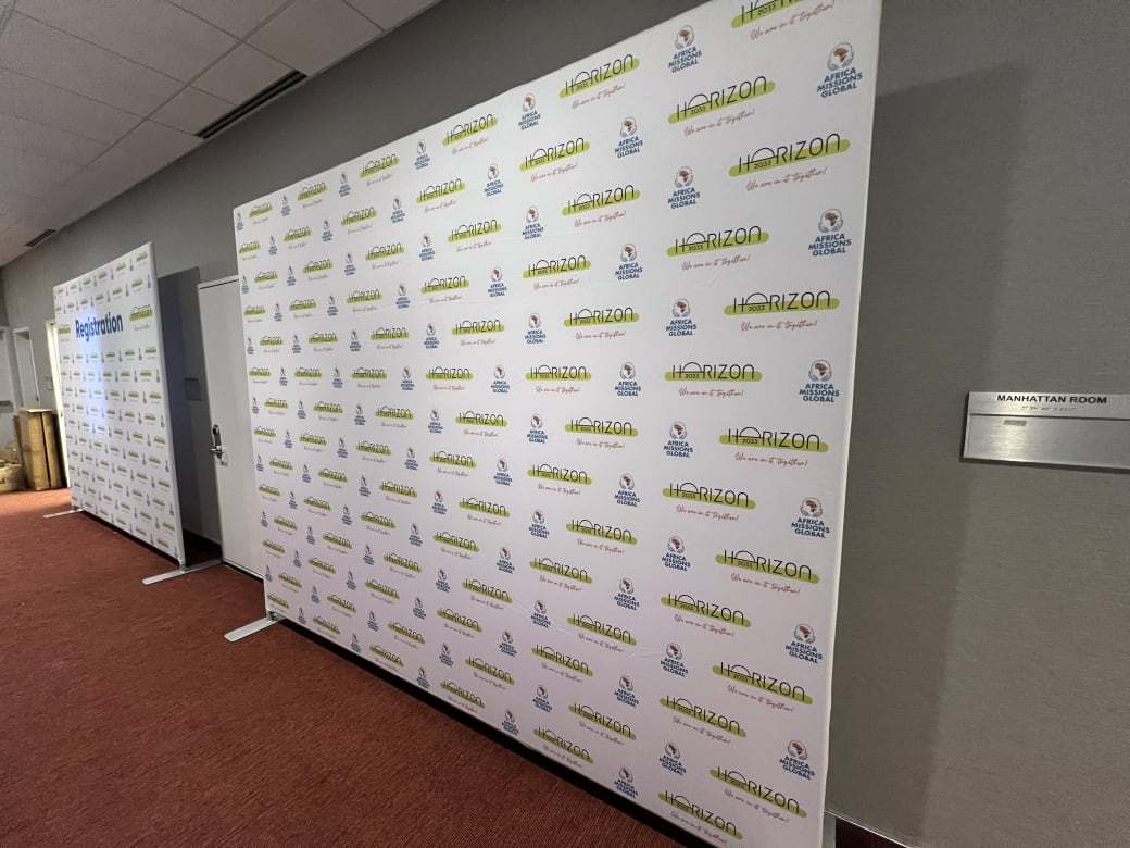 Horizon 2033 step-and-repeat banner in the hallway outside the Manhattan Room, with the registration backdrop beyond