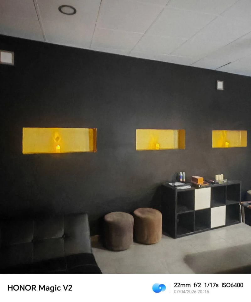 Lounge area with candle niches, leather sofa and brown poufs