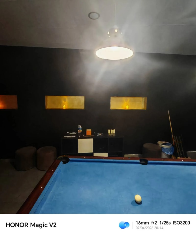 Pool table from cue ball perspective with pendant lamp overhead