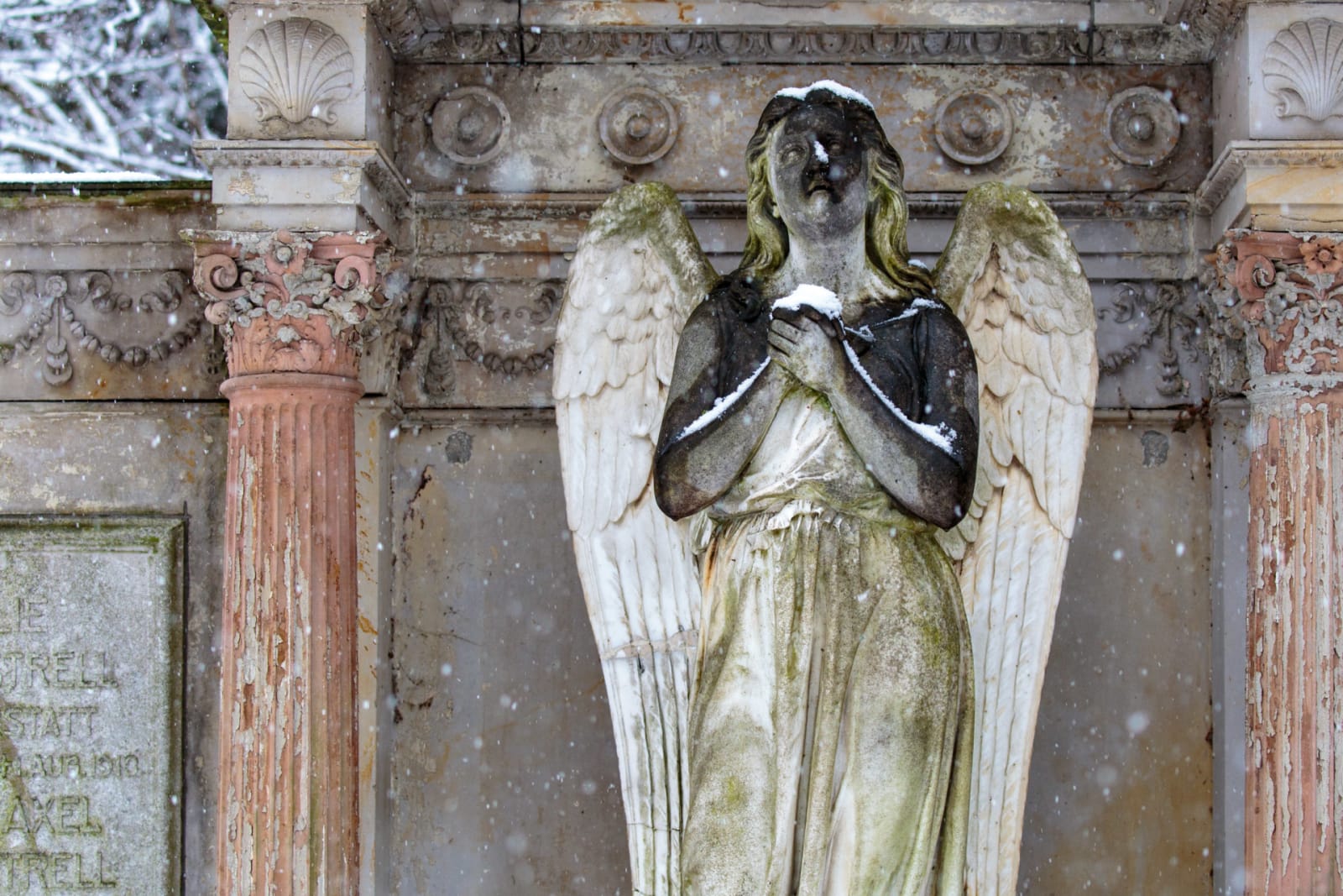 Prayerful Angel Under Light Snowfall