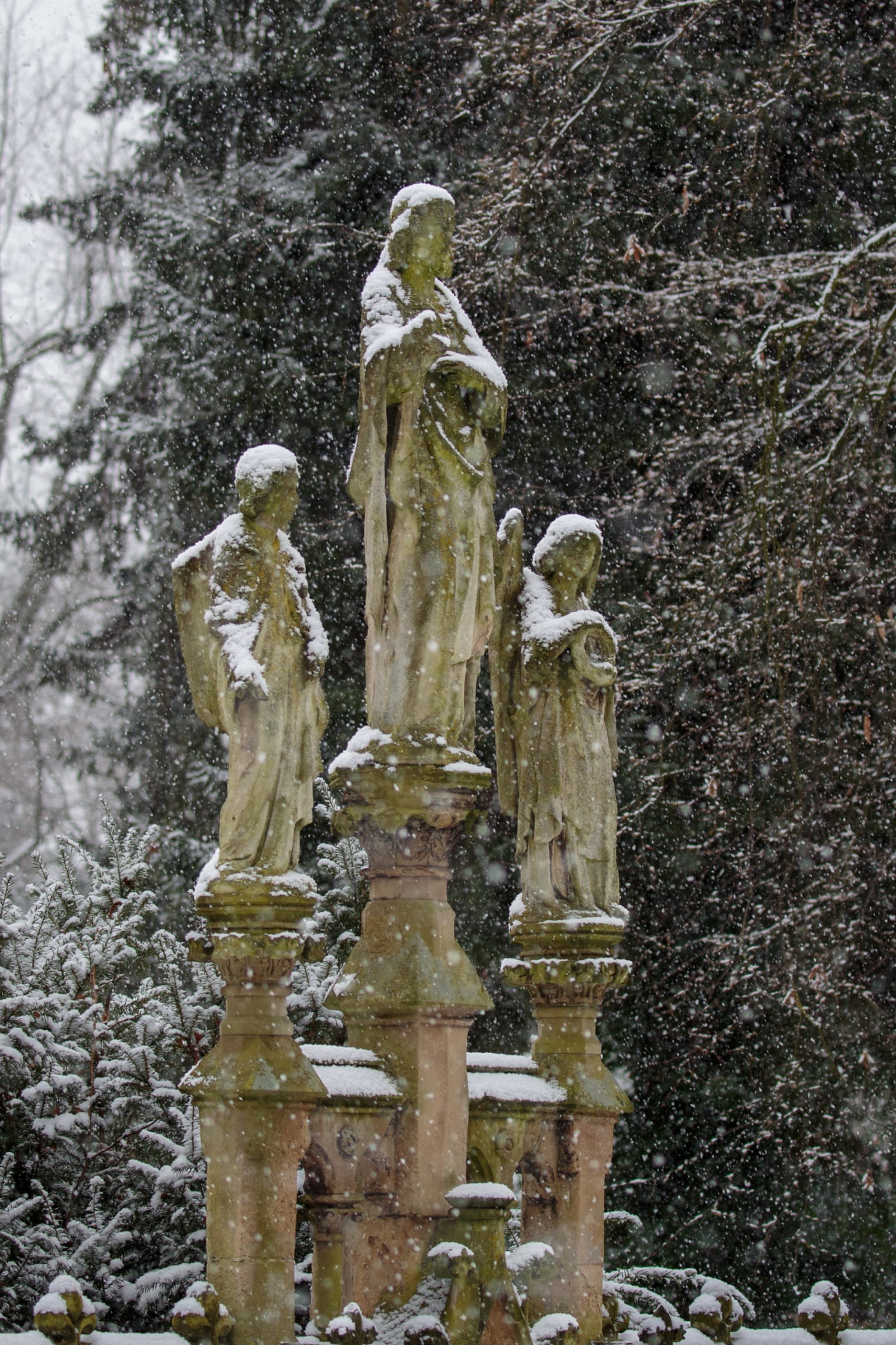 Stone Figures and Falling Snow