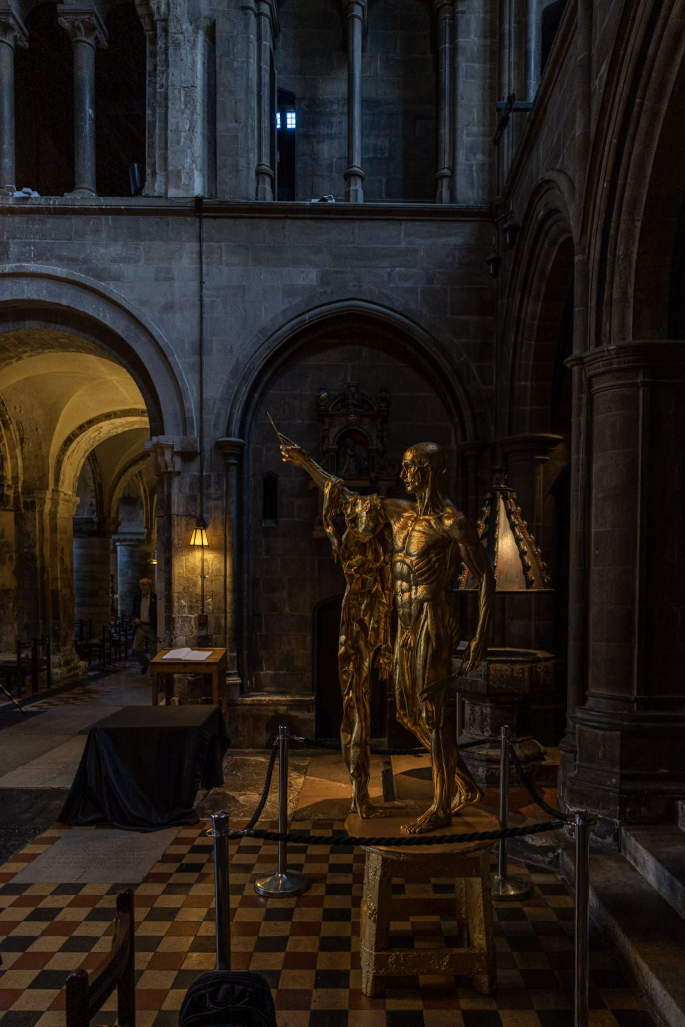 Gilded Figure on Checkerboard Floor