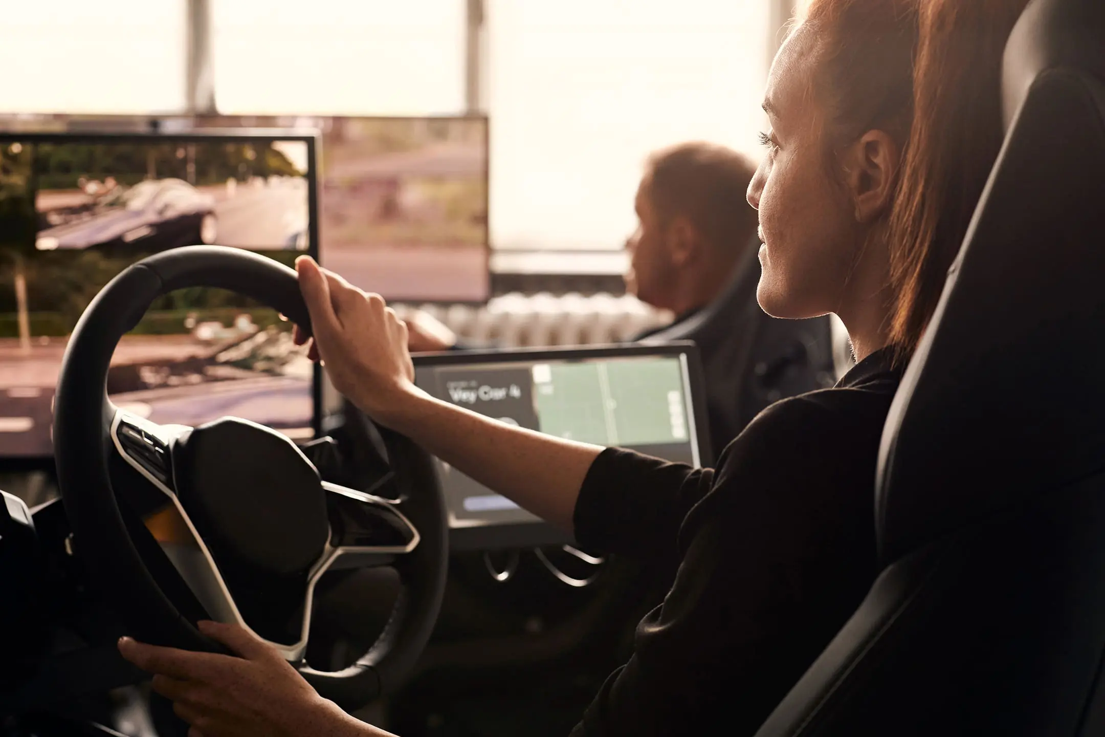 A remote operator monitors live vehicle camera feeds from a teleoperation control station