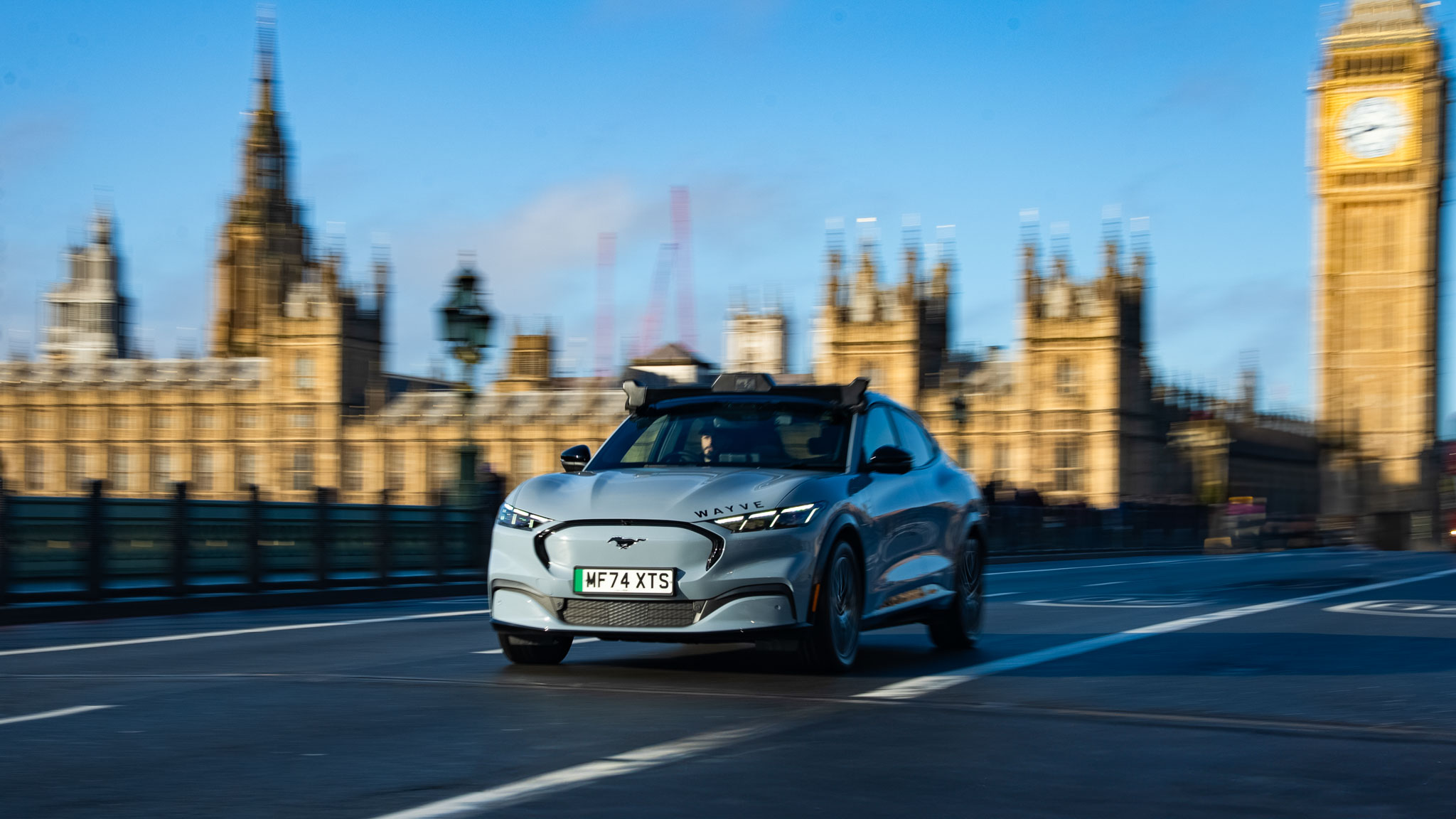 A Wayve autonomous Ford Mustang Mach-E driving on a London street