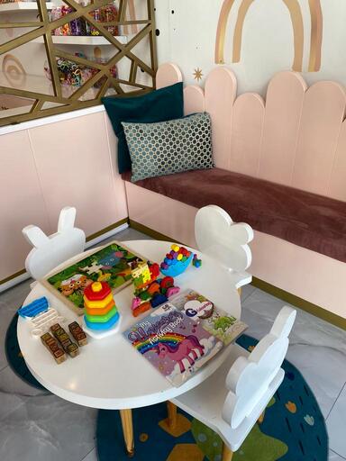 Luxury kids' salon waiting area with comfortable seating and entertainment