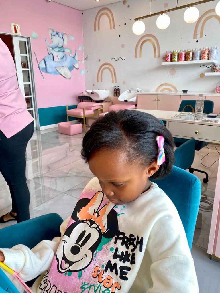 Kids' hair makeover: A confident young client showcasing their new, stunning hairstyle
