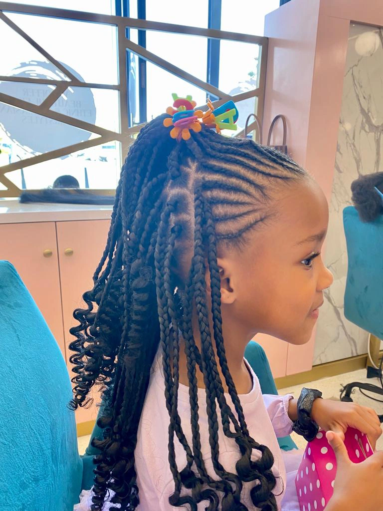 Elegant children's hairstyling in progress by our skilled and creative team