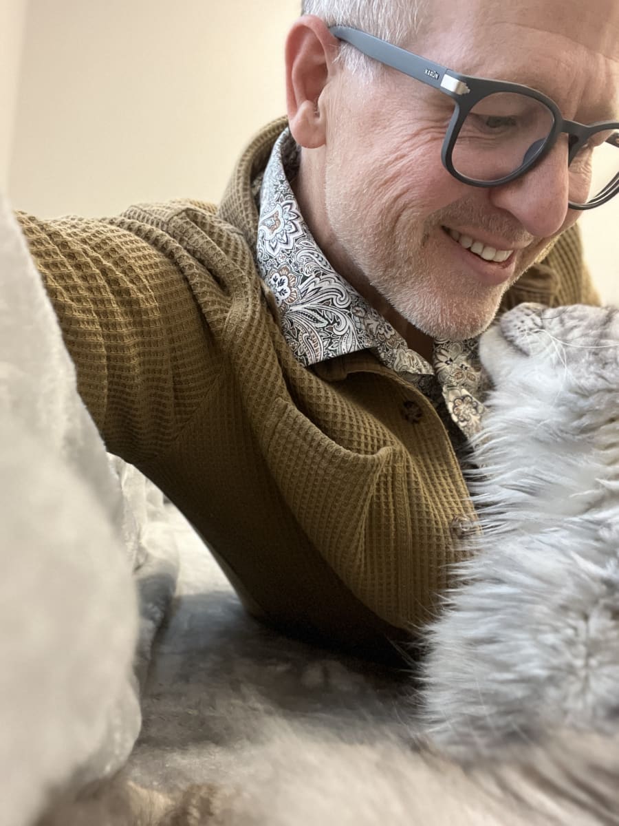 Away Home & Pet Care founder with silver cat during in-home cat sitting visit in Ogden Utah