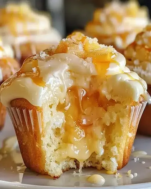 A batch of delicious honey peach cream cheese cupcakes ready to be frosted.
