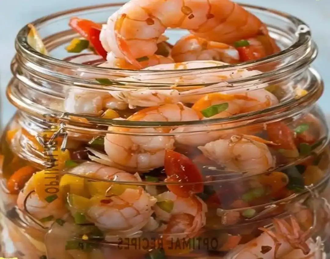 Plump, succulent shrimp marinated in a vibrant, herb-flecked brine, ready to be served as an appetizer.