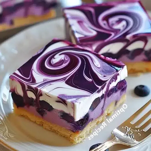 A beautifully layered no-bake blueberry cheesecake in a springform pan, showcasing the crumbly base, creamy filling, and vibrant blueberry topping.
