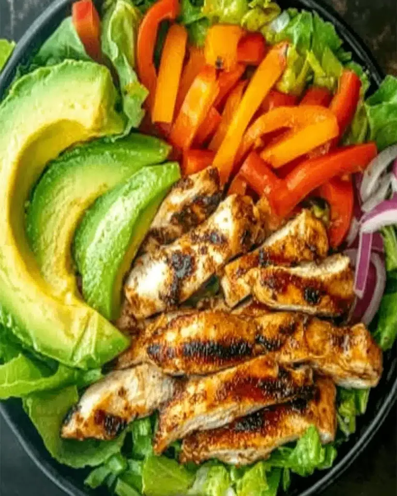 Grilled Chili Lime Chicken Fajita Salad with fresh vegetables and avocado.