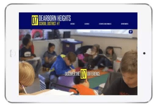 Tablet displaying the Dearborn Heights School District website with a banner reading 'Discover the D7 difference' and an image of students reading.