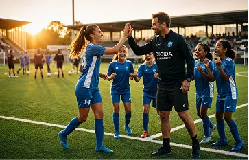 Youth football team celebrating with their coach