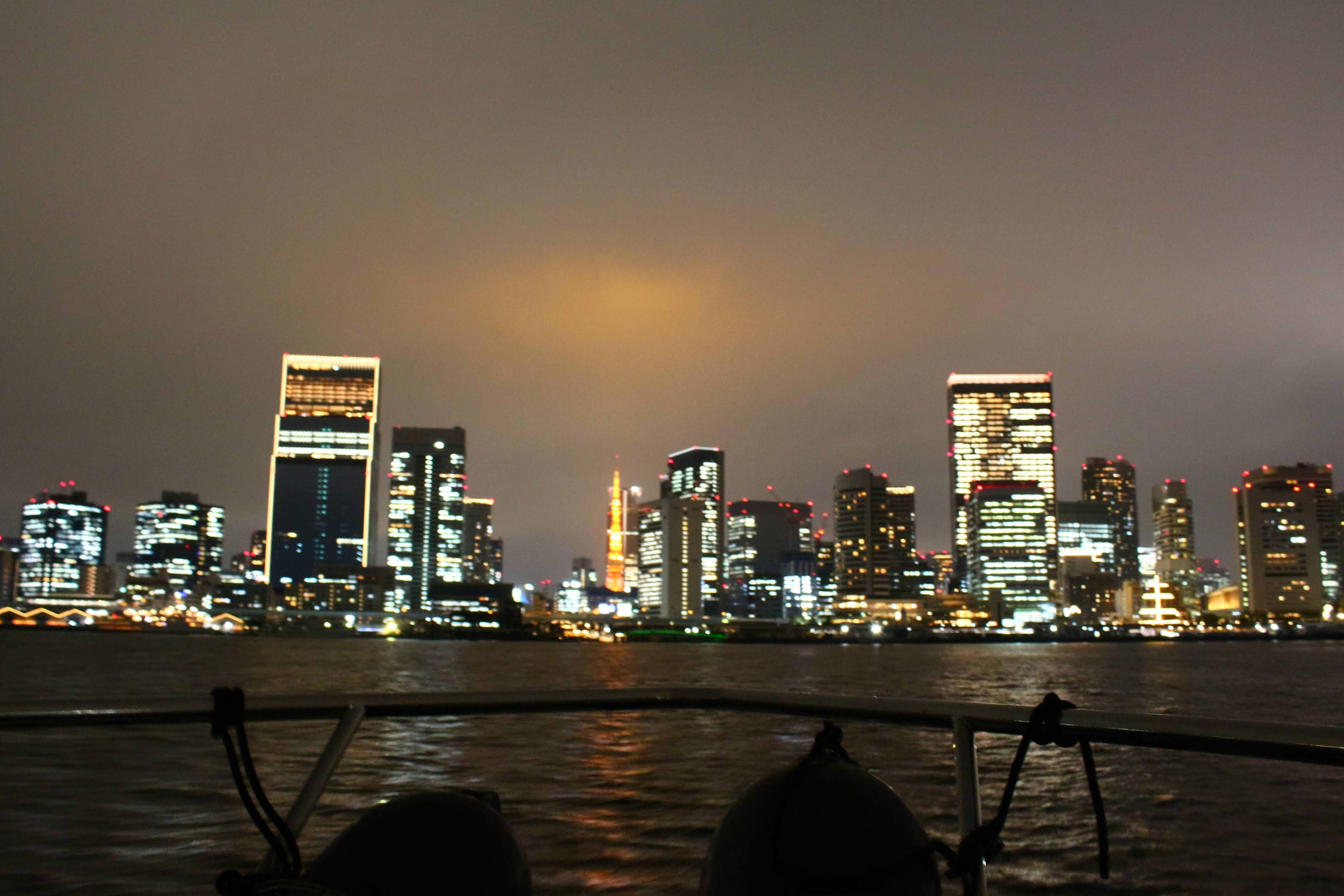 Tokyo skyline at night, reflected in the bay