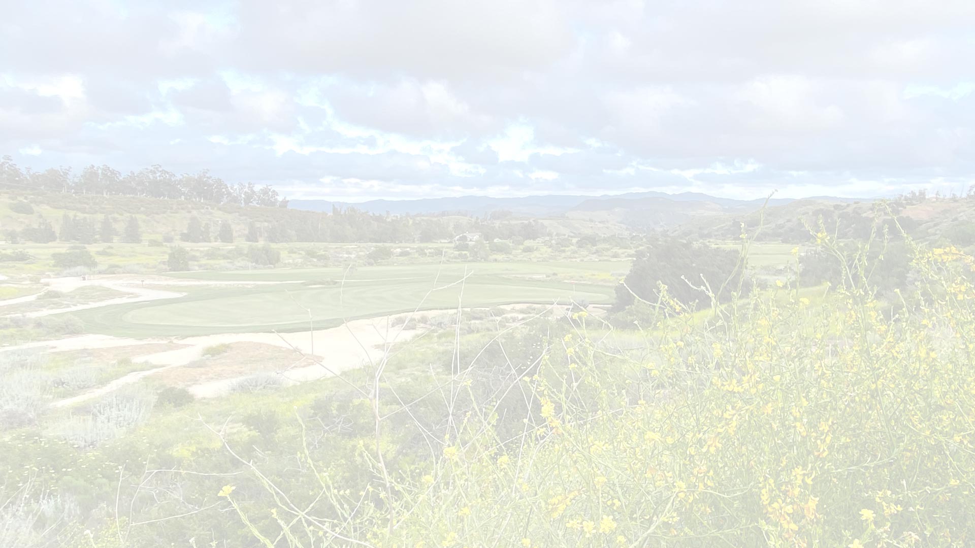 An overexposed, washed-out landscape view showing distant terrain with poor contrast and minimal visible detail due to lighting issues.