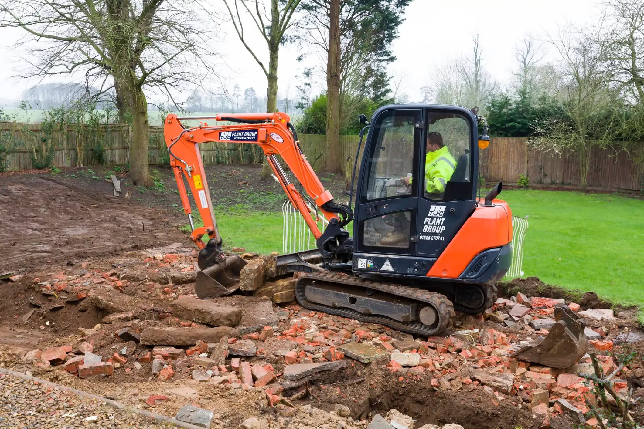 Gardener in a digger doing landscaping