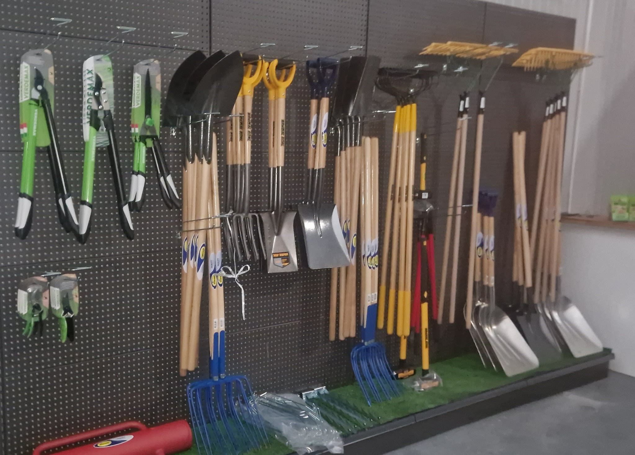Garden tools hanging inside landscaping store for sale