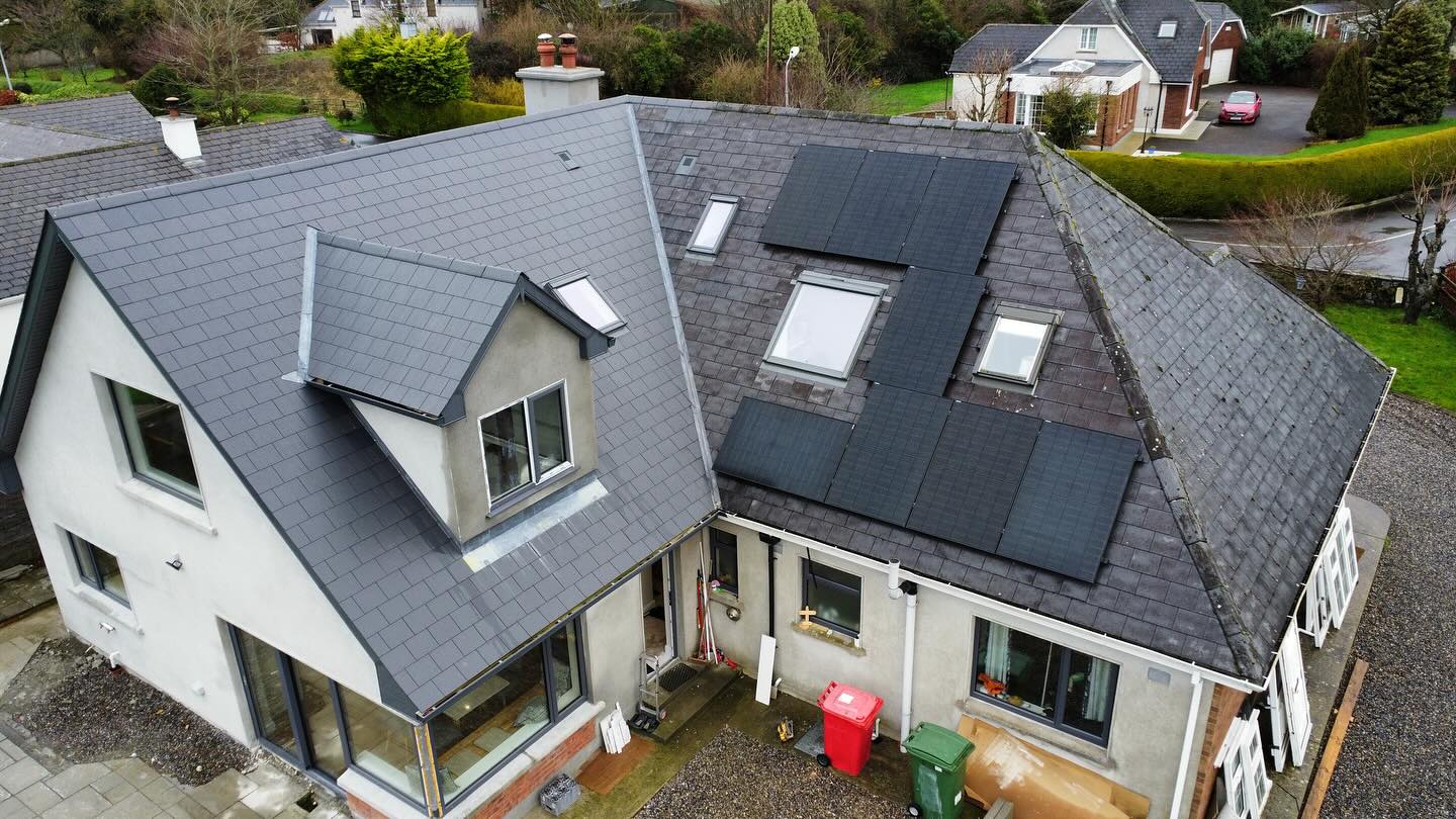 image from a drone above a house looking at newly added extension and solar panels on the roof