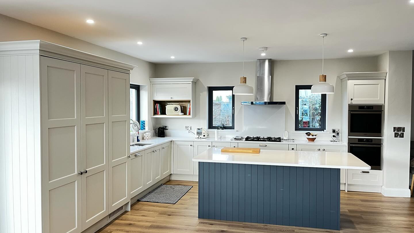 An image of a newly refurbished kitchen with new lighting and counter tops.