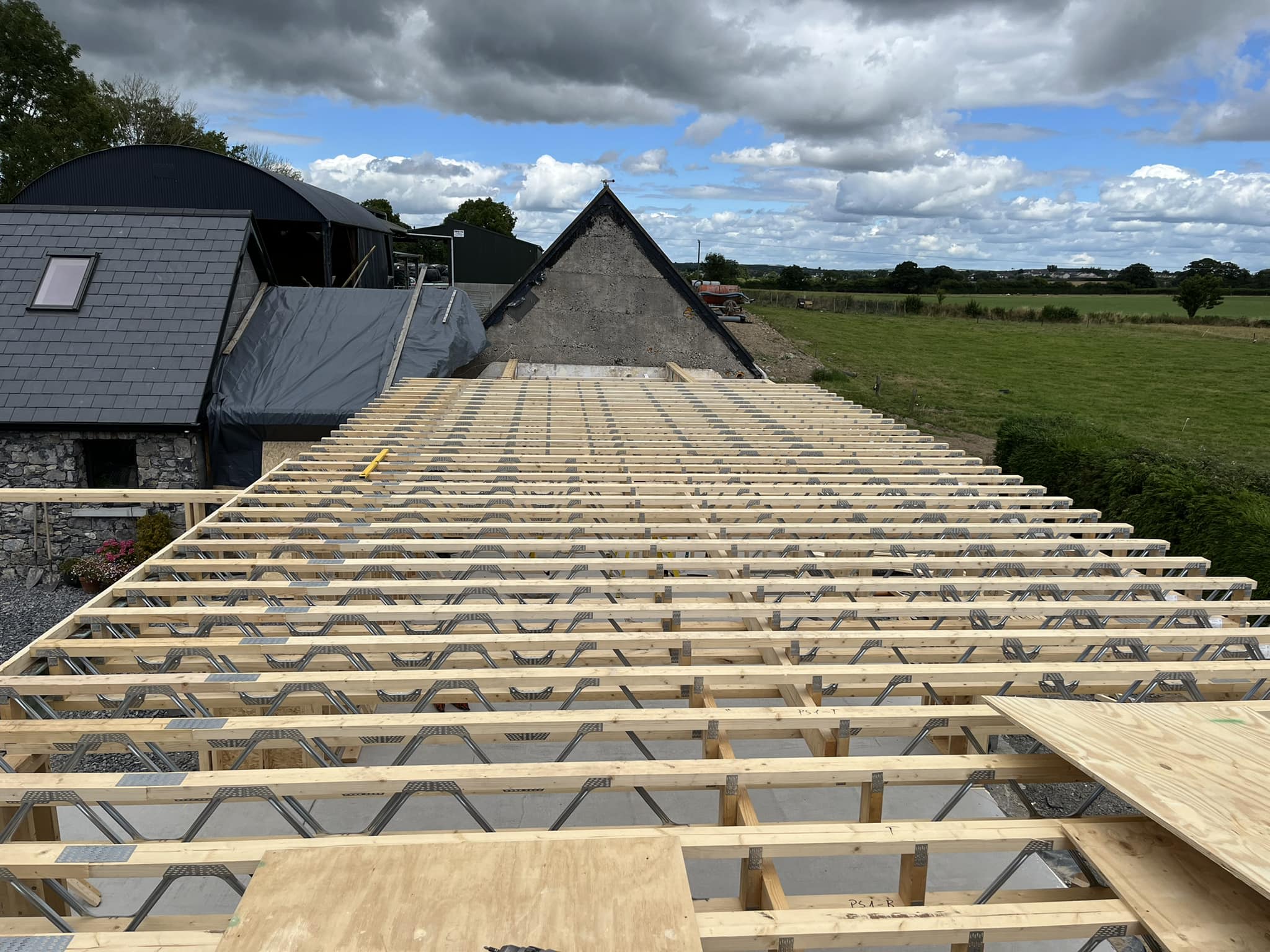 timber frame extension roof being constructed