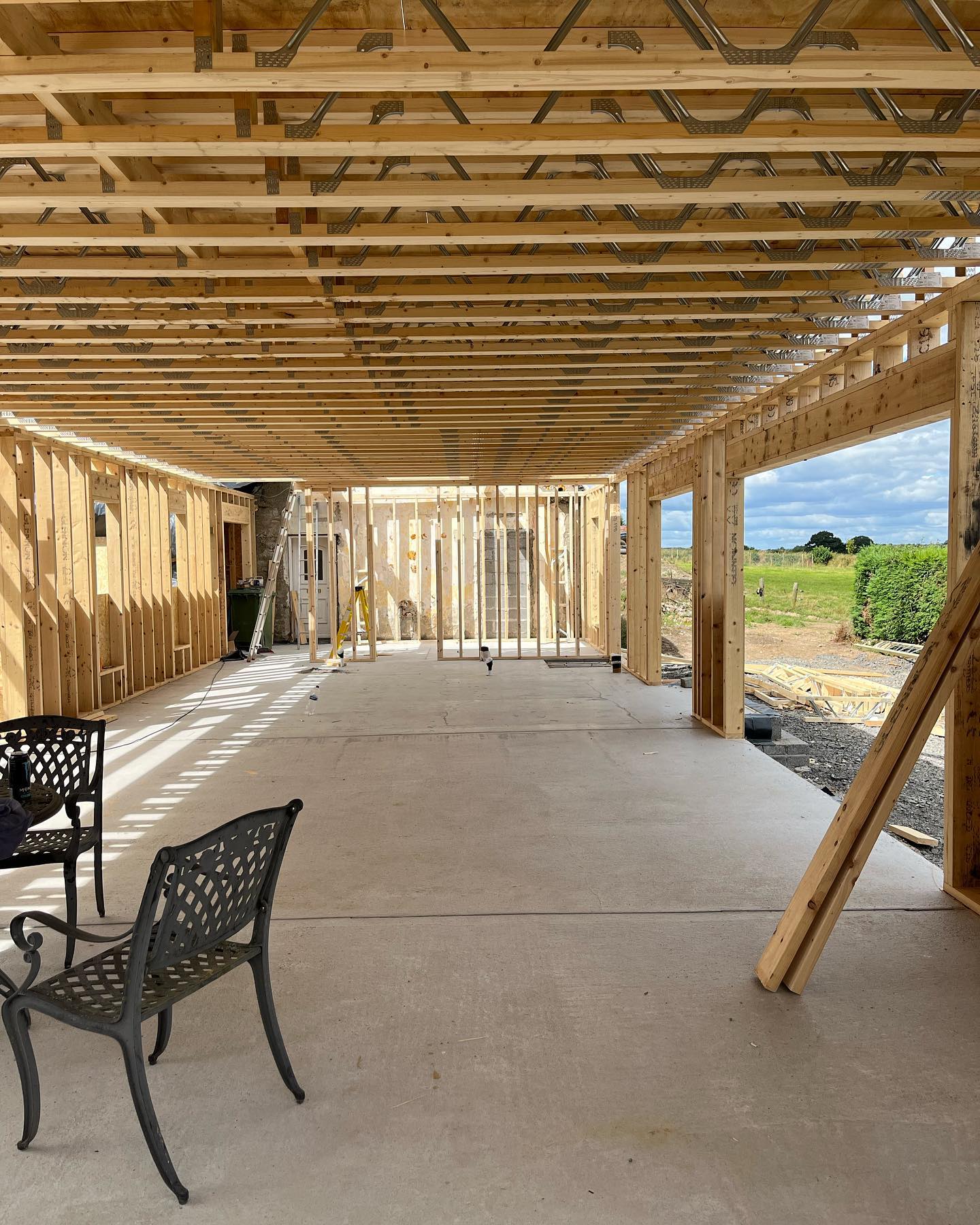 An image of a timber frame extension being build onto the side of a house