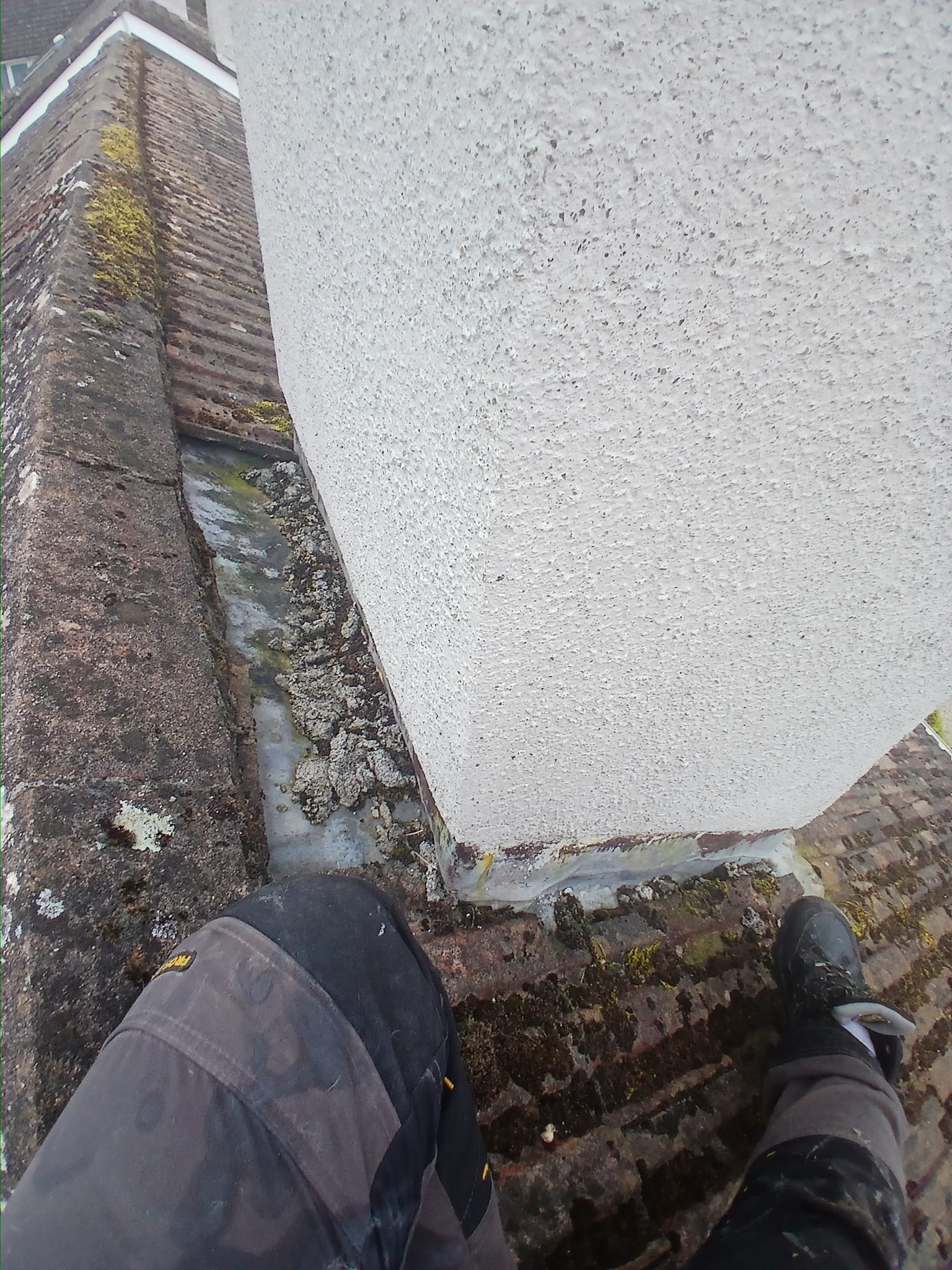 A roof chimney in Dublin with a broken lead flush around it.