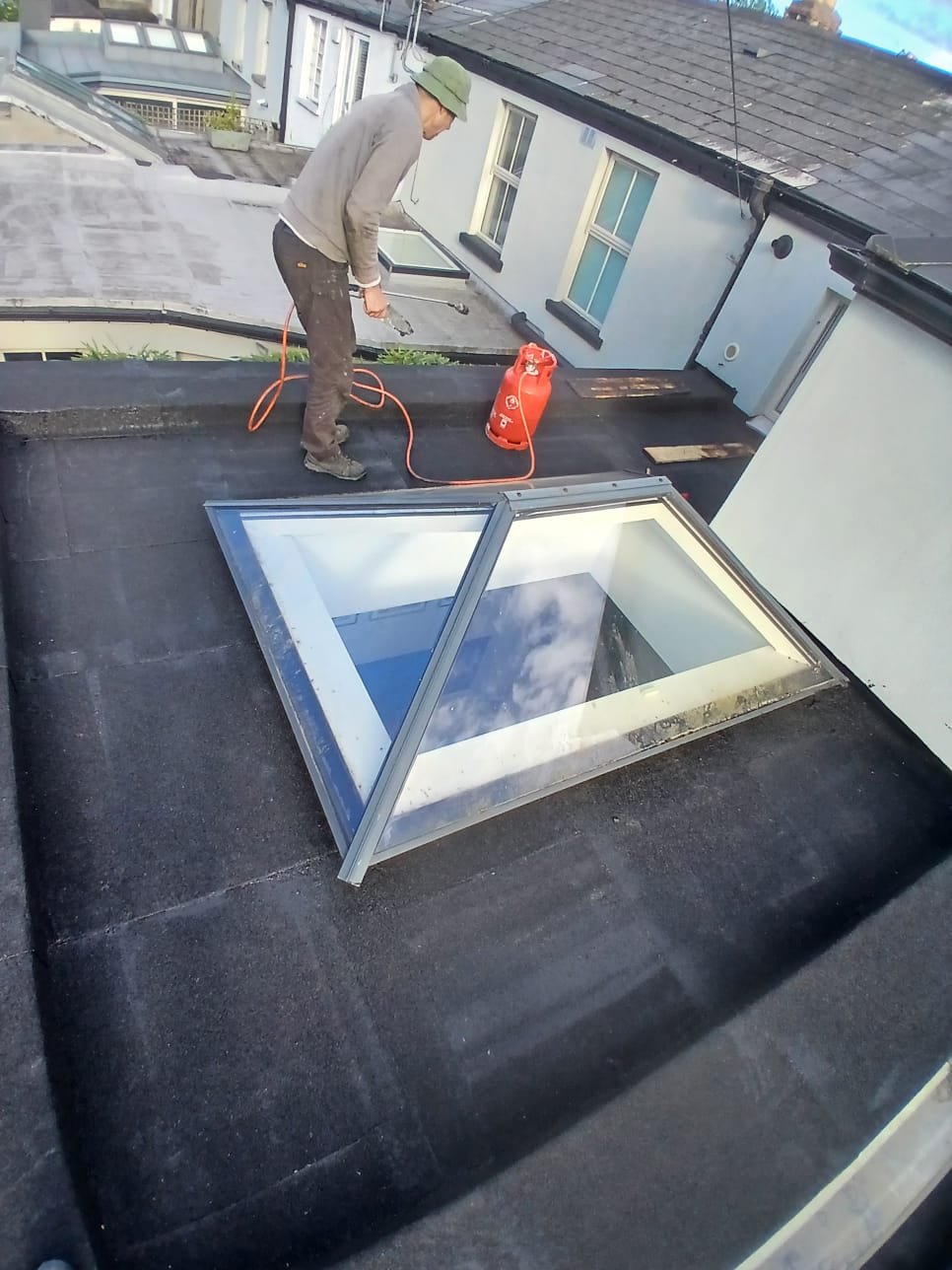 Flat roof with a leaking skylight being repaired in Dublin  