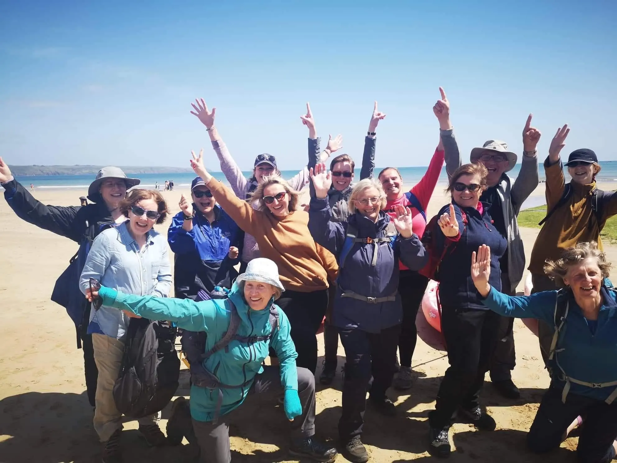 group of walkers at Ardmore on the beach at the end of Saint Delcans Way Ireland