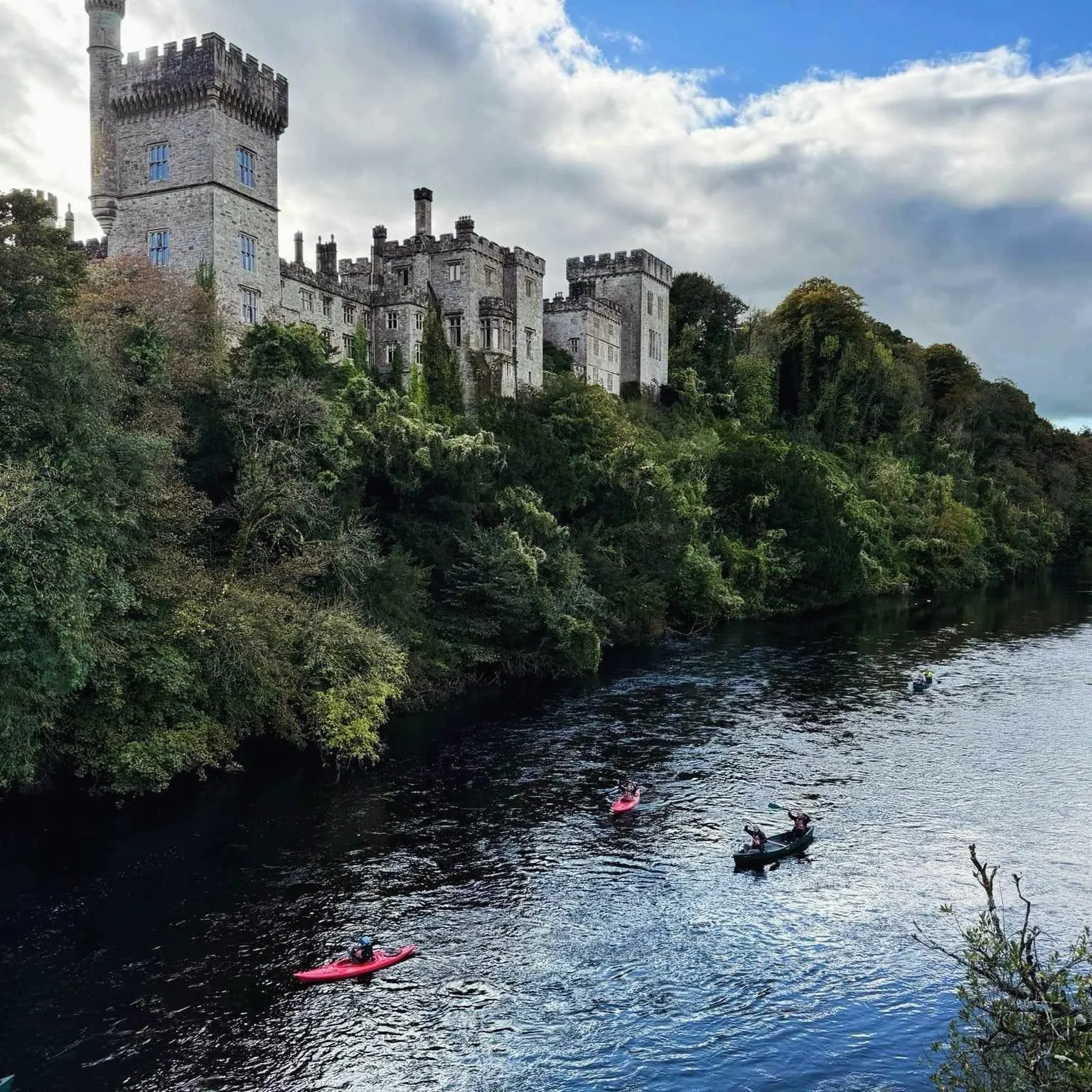 Tour group kayaking on the river by Lismore Castle in Co. Waterford