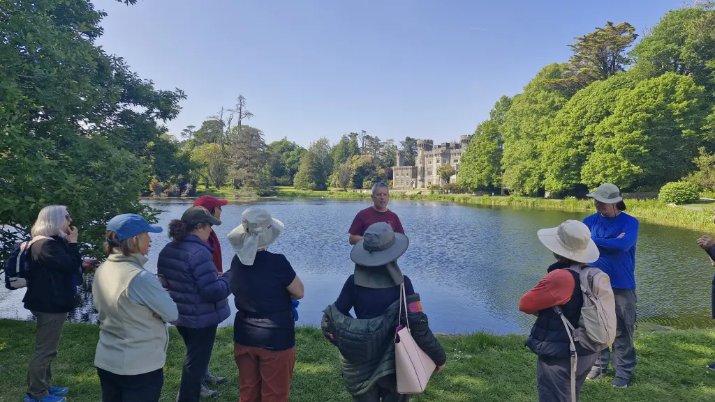 9880c115-982e-4114-aaf7-af8a9c9995a2 tour group in front of a lake in Johnstown Castle - estate & gardens Co. Wexford Ireland