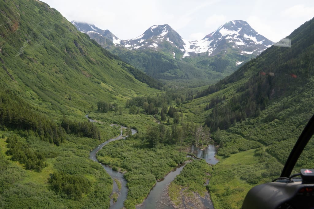 Green valley and mountains seen from the helicopter