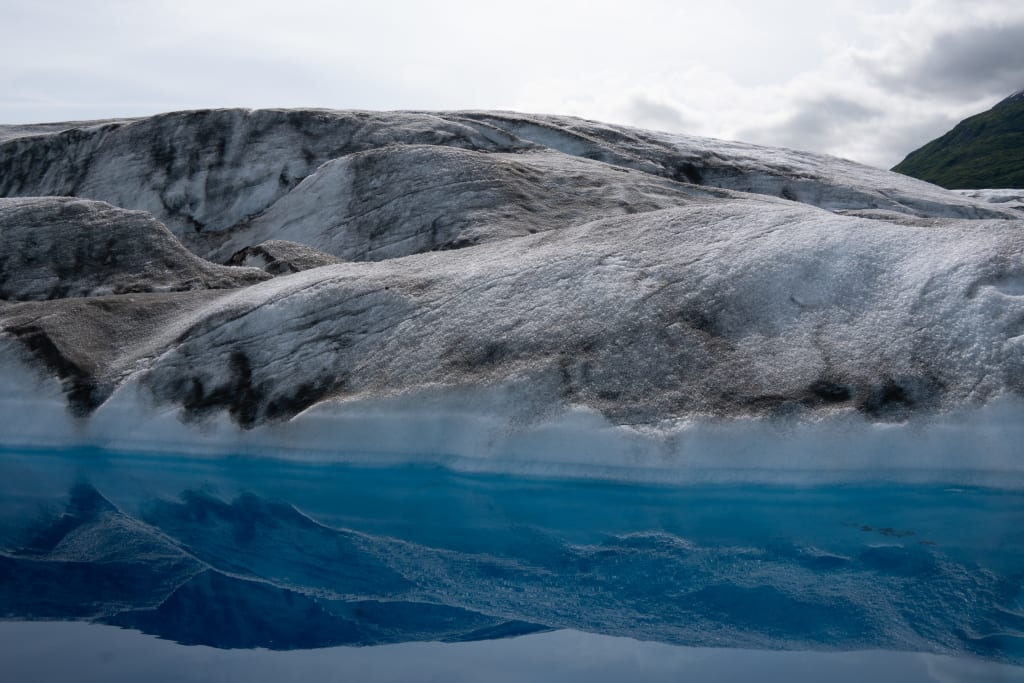 Looking into a bright blue glacier pool