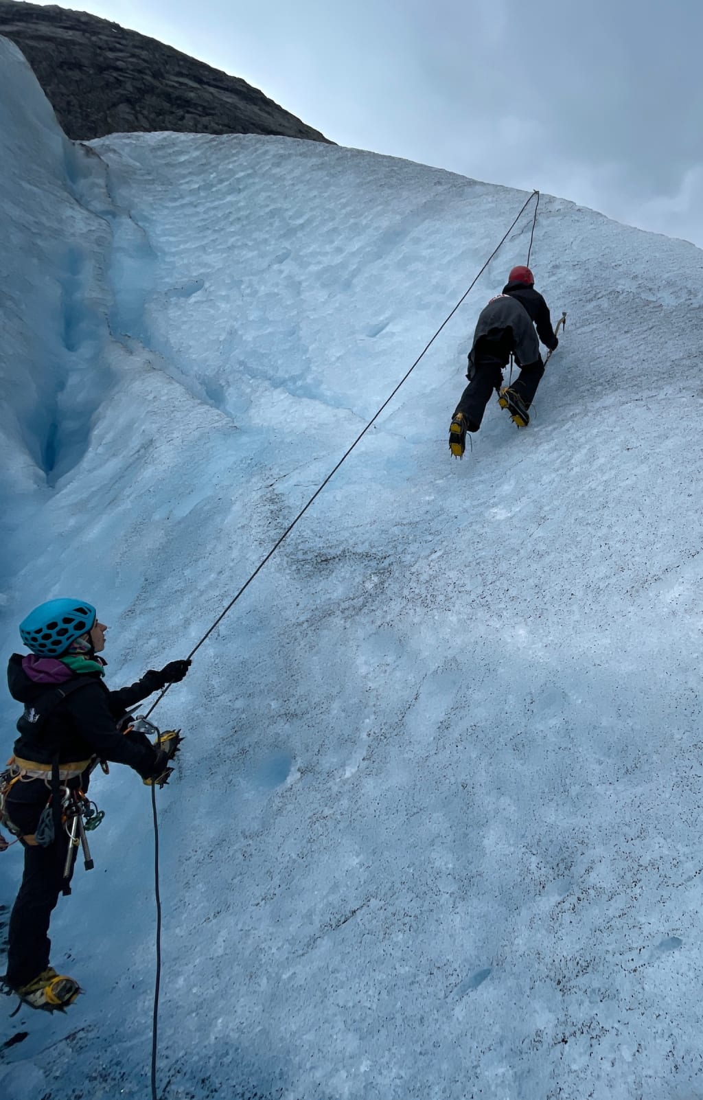 Trying ice climbing on a short wall of glacier ice