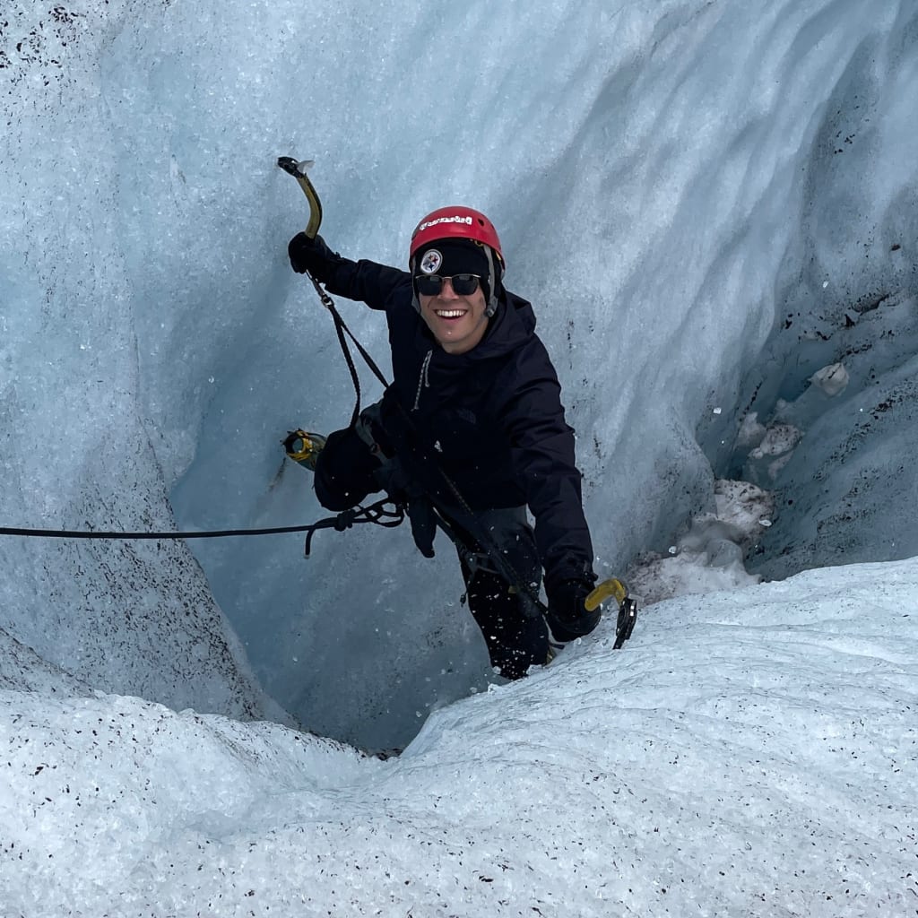 Alex climbing on blue glacier ice in Norway