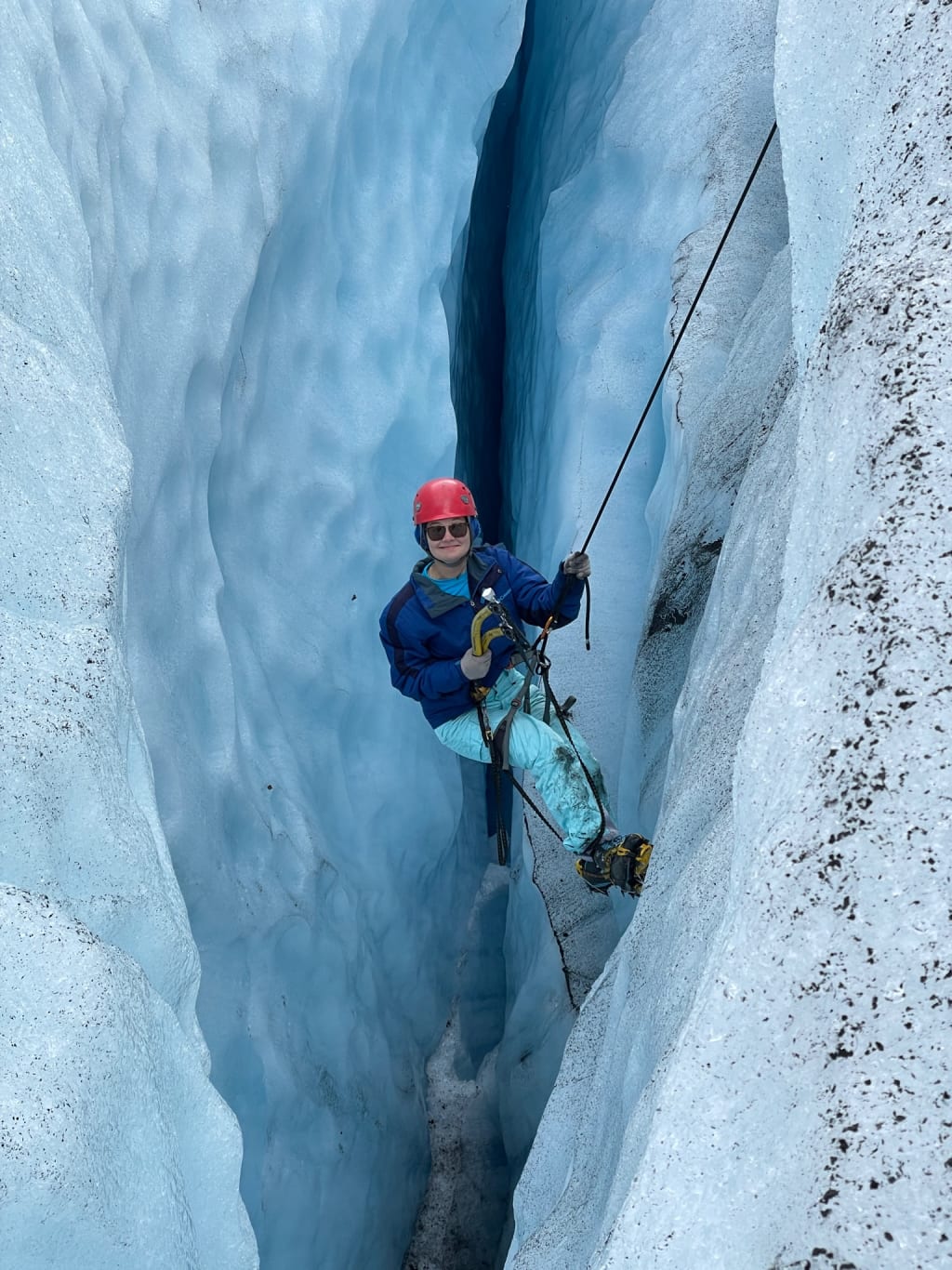Being lowered into a blue crevasse on Jostedalsbreen Glacier