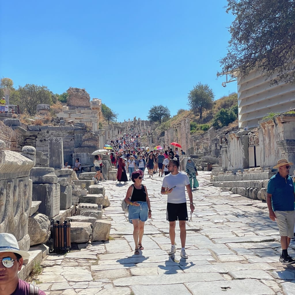 Visitors gathering near the Library of Celsus
