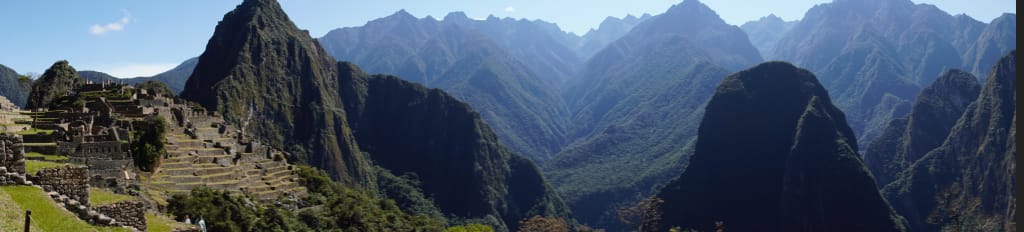 Machu Picchu balanced on a ridge in the Andes