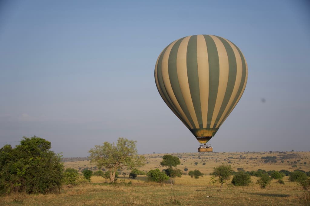 Hot air balloon seen from the ground in the Serengeti