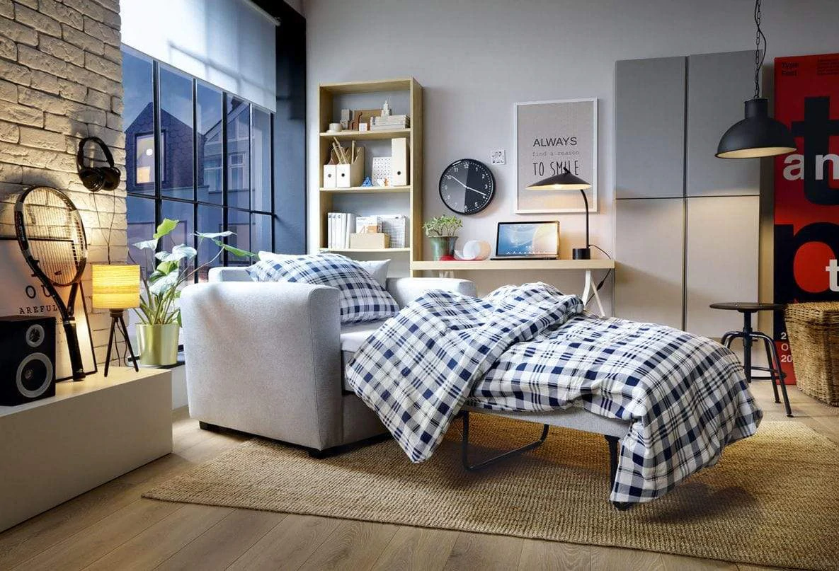 abakus direct olly single sofa bed in a fully furnished room with a blanket and pillows