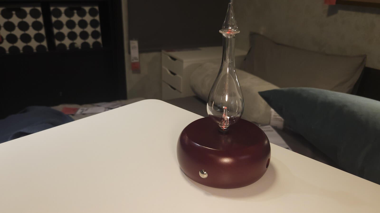 cold air diffuser with cherry wood base and clear Pyrex glass top on a bedroom nightstand