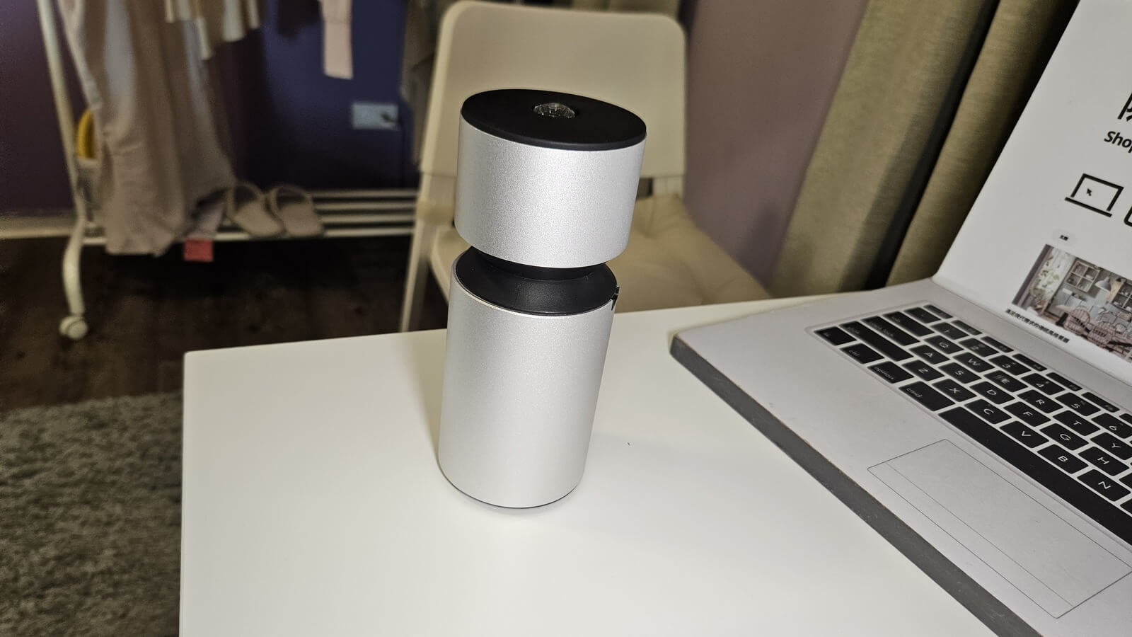 Smart Nebulizing Diffuser cold air aromatherapy device next to a laptop on a white desk