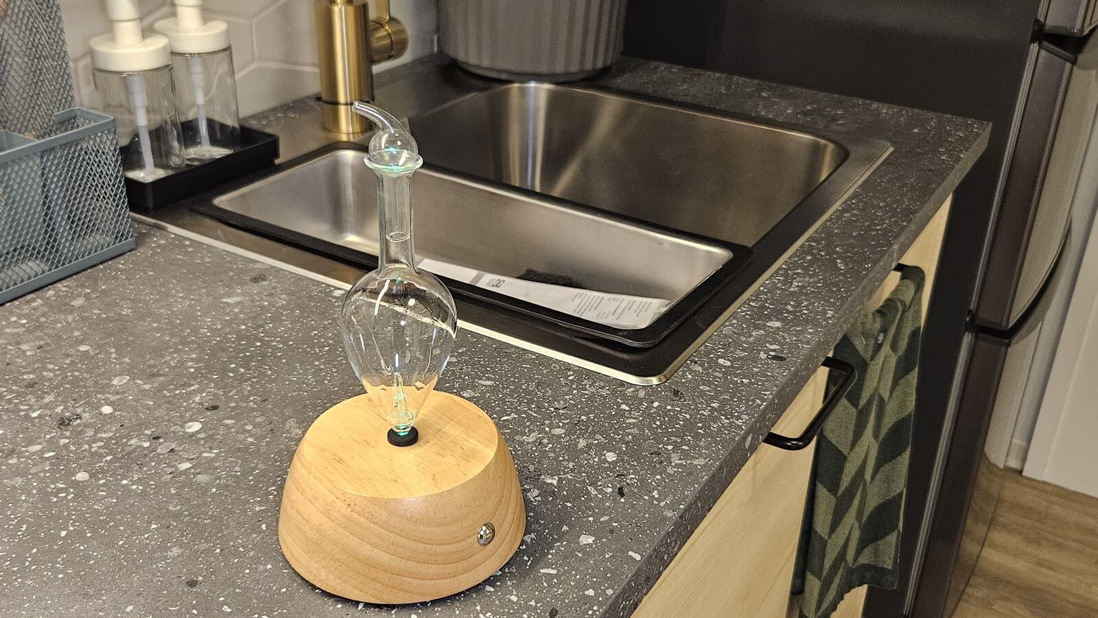 Organic Aromas Nebulizing Diffuser with peppermint essential oil on a kitchen counter