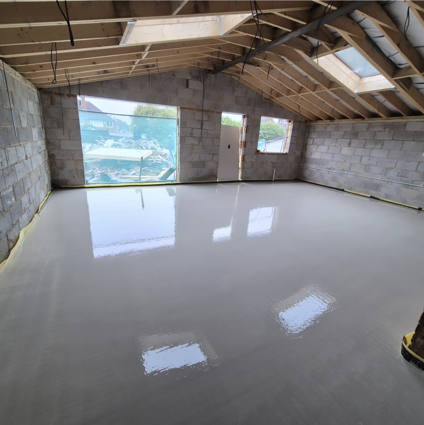 Bright empty room with freshly poured liquid screed floor