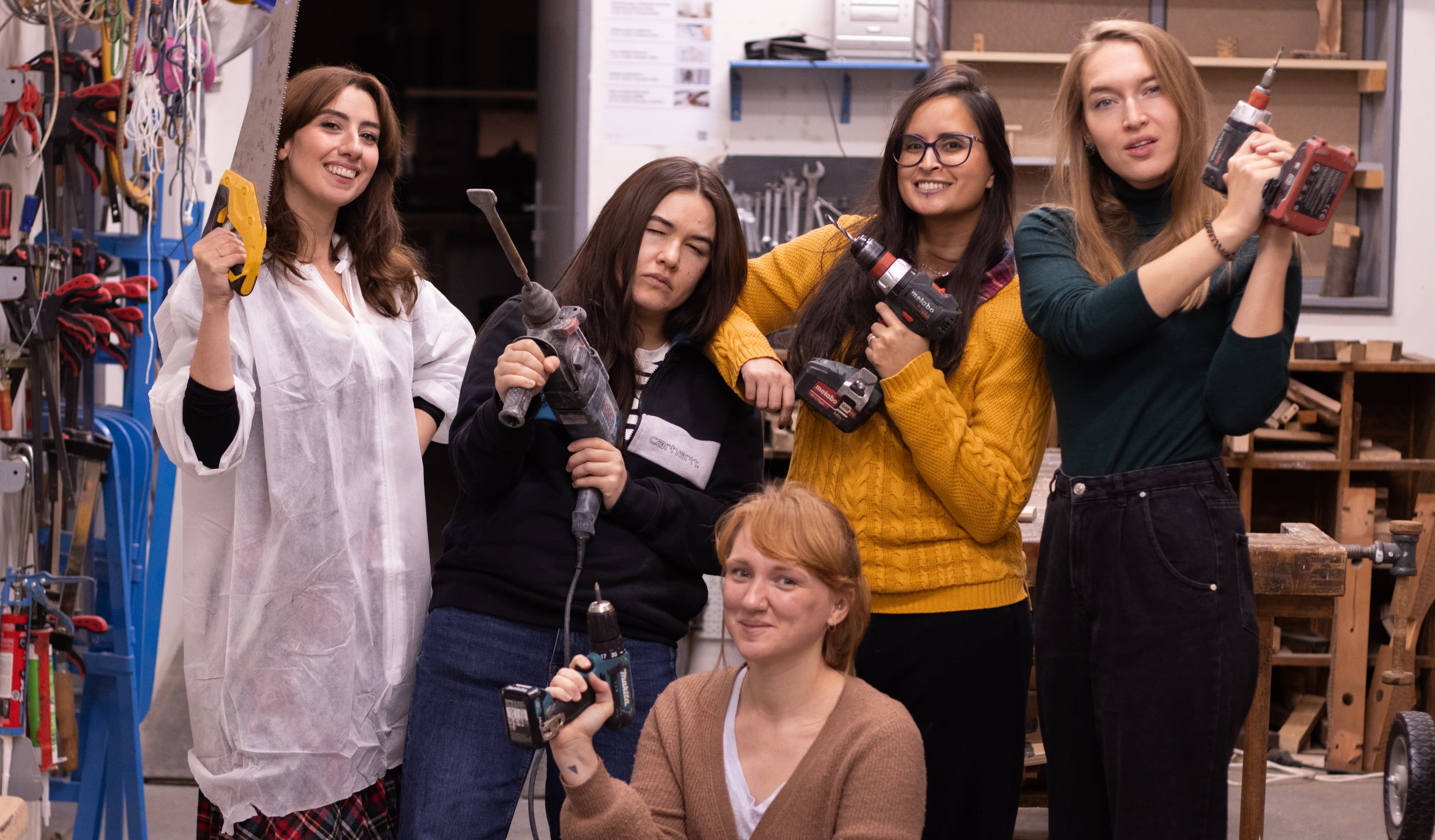 Women learning to use power tools